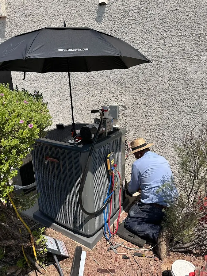 HVAC technician performing outdoor AC maintenance in Elma